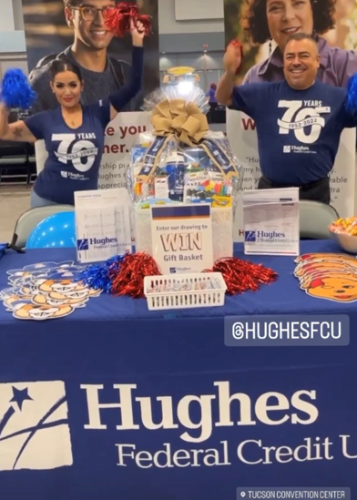 Hughes team poses in front of event table