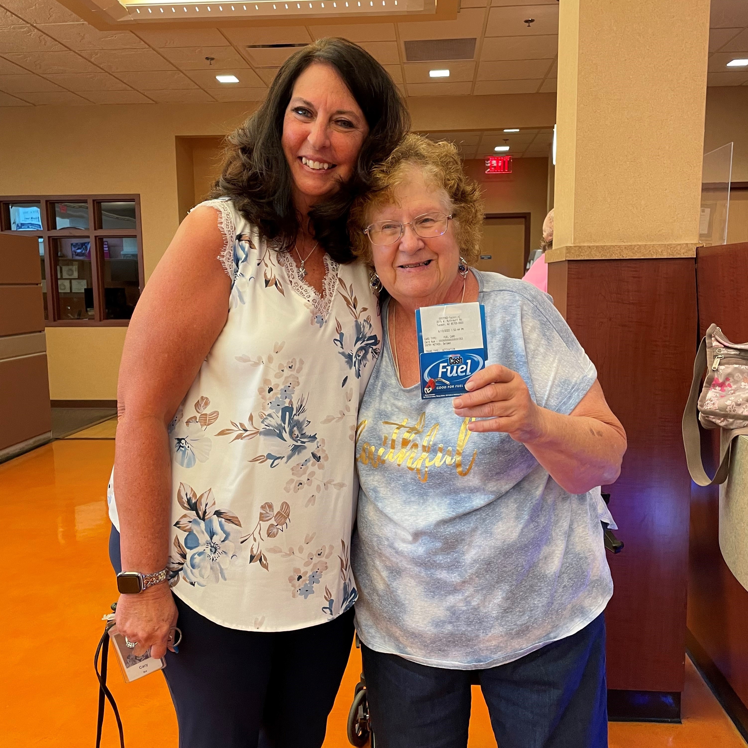 Hughes employee poses with gas card recipient