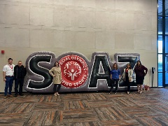 Group poses with SOSA Sign