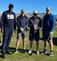 Hughes team poses in golf gear for Golf Challenge Event