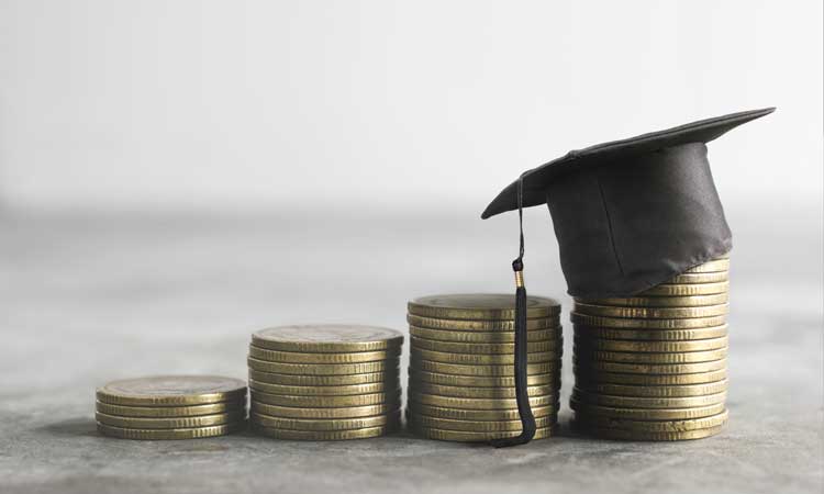 stack of coins and a graduate's cap