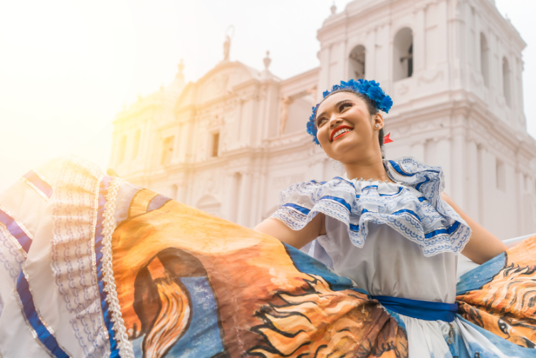 A young Hispanic woman in traditional Folklórico clothing.