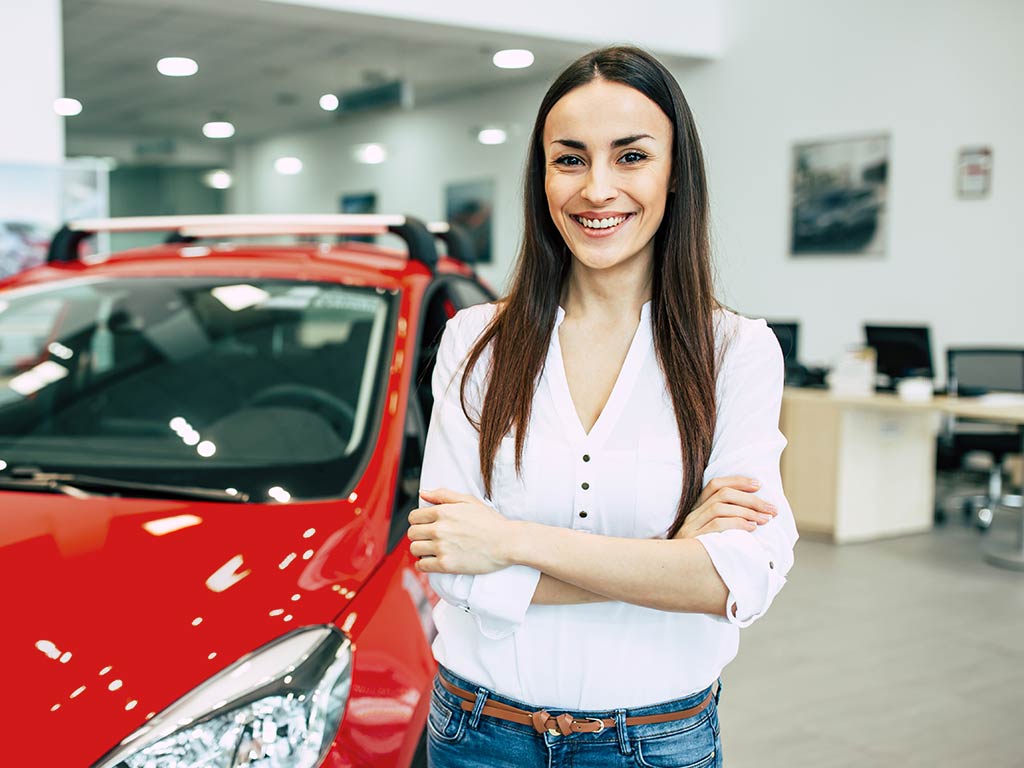 Woman standing in car showroom