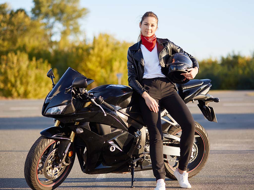 Woman sitting on motorcycle