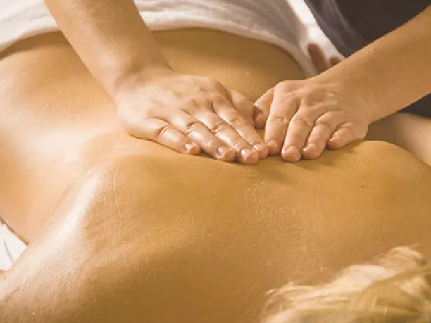 Hands on a back, giving a massage.